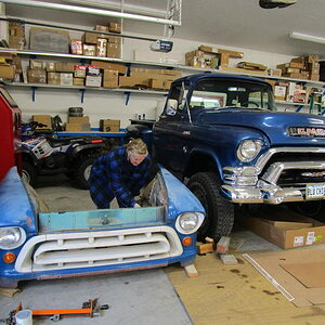 103  SHOP FORMAN WOMAN INSPECTS THE RADIATOR SUPPORT- SHE ADVISED CHROME ON THE GRILLE HEADLITE BEZELS AND BUMPER -- SMART GAL